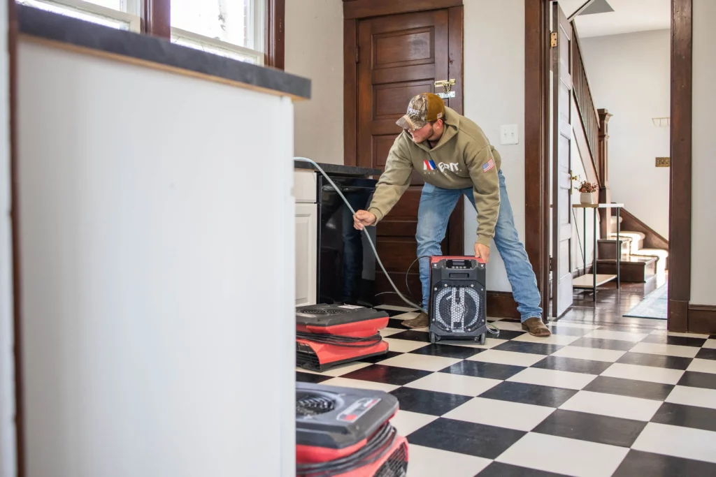 worker doing water damage restoration services